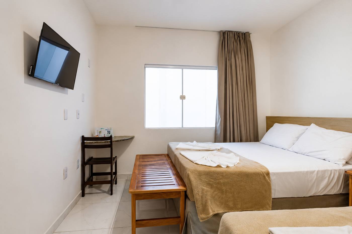 Quarto Duplo Standard com cama de casal, mesa e televisão